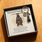 Keychain with a bat providing emotional support and a card with a message