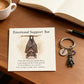 Keychain with a bat providing emotional support and a card with a message